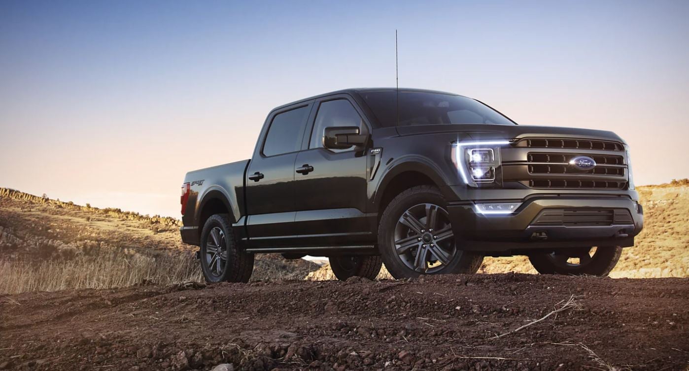 A black 2021 Ford F-150 Crew Cab parked near a construction site in Dickinson, TX